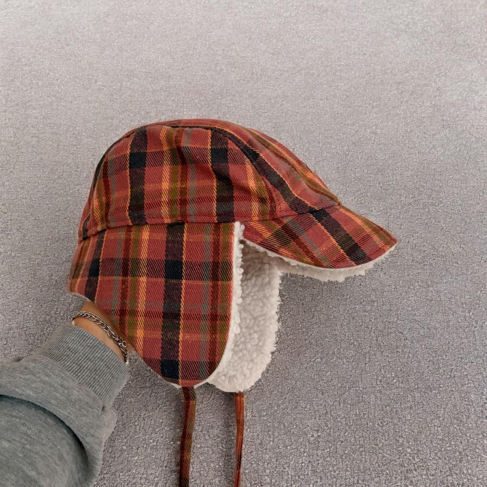 Trapper ear flap winter hat in checkered navy blue pink brown colour way. One size.