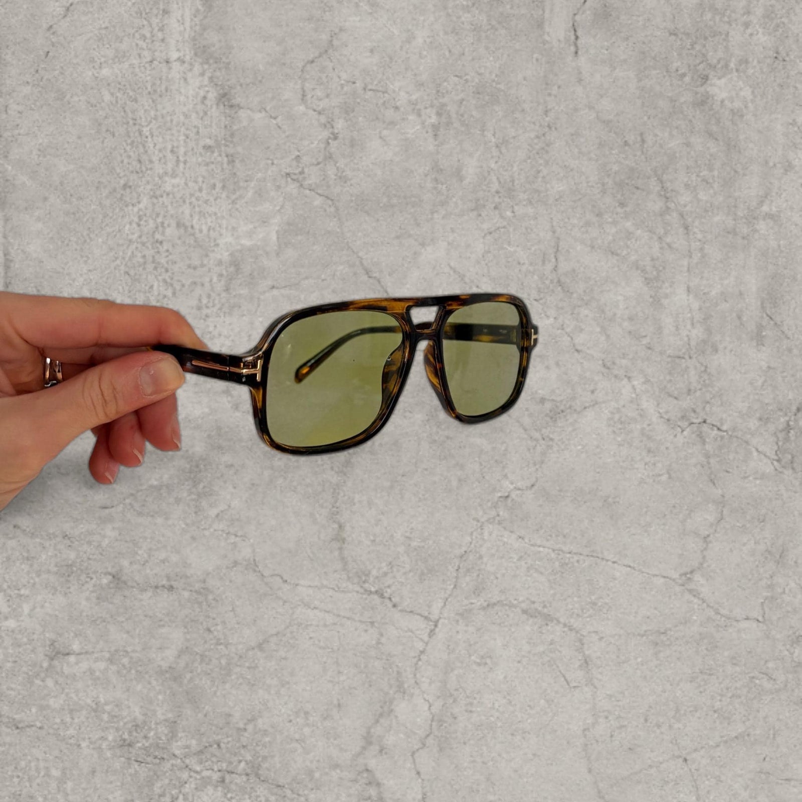Vintage style aviator sunglasses with green tinted lenses in tortoise shell frame