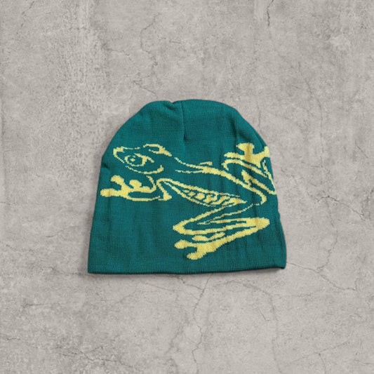 Green knit beanie hat with yellow graffiti style frog graphic on front