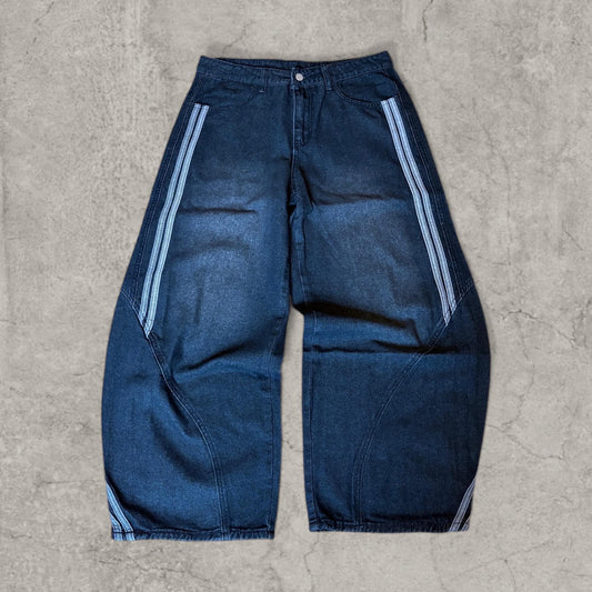 Wide-leg washed black jeans laid flat with blue stripe detail on side panels