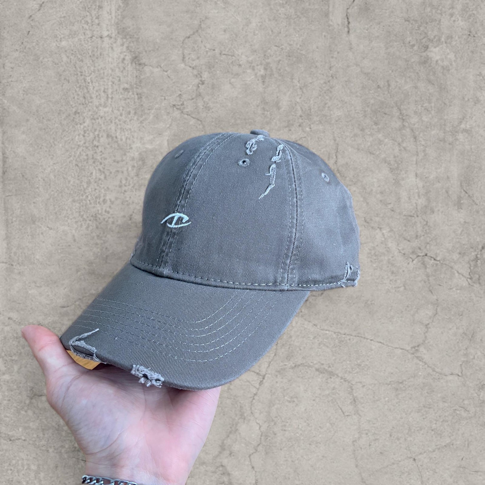 Vintage style baseball cap in beige grey with white embroidery. One size