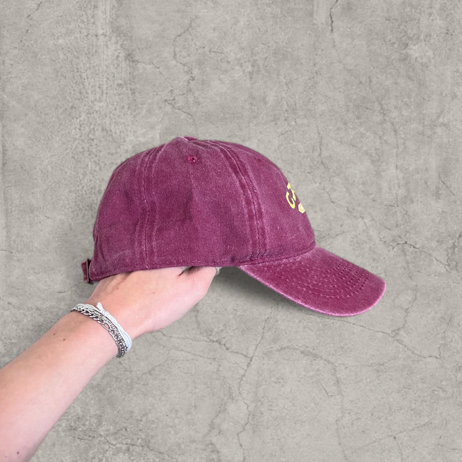 Vintage style baseball cap with yellow camel logo in burgundy