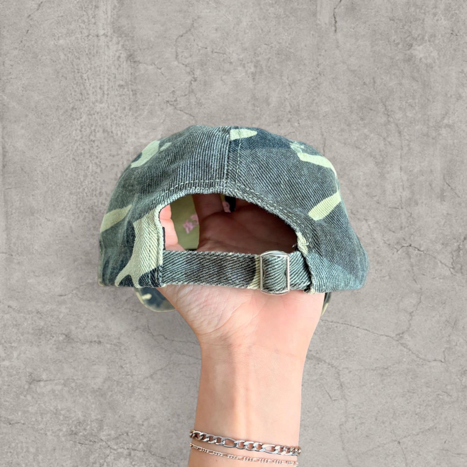 Vintage style baseball cap in khaki green camo print with pink gothic logo
