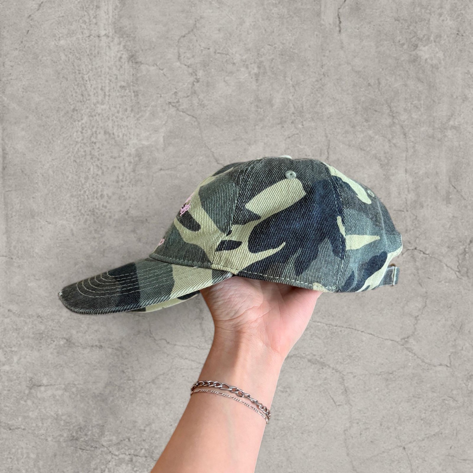 Vintage style baseball cap in khaki green camo print with pink gothic logo