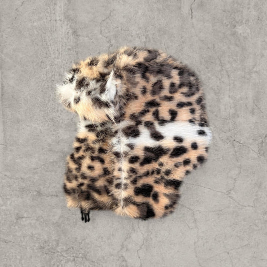 Russian ushanka furry winter hat in cream beige leopard print laid flat showing side details