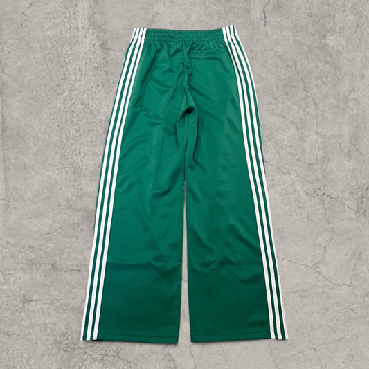 Dark green baggy trousers with white stripes laid flat, front view