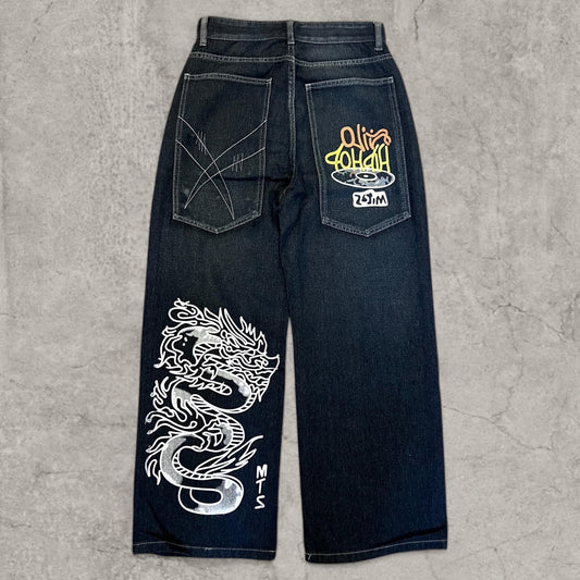 Back view of wide leg navy blue jeans with large white and yellow Japanese dragon print on leg and graphics on back pockets