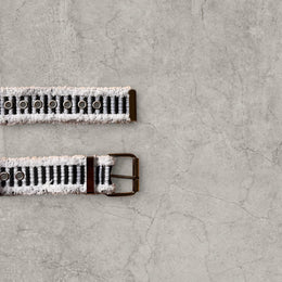Cool distressed denim belt in black ad white with grey eyelet and silver metal buckle. Adjustable
