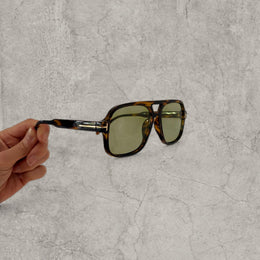 Vintage style aviator sunglasses with green tinted lenses in tortoise shell frame