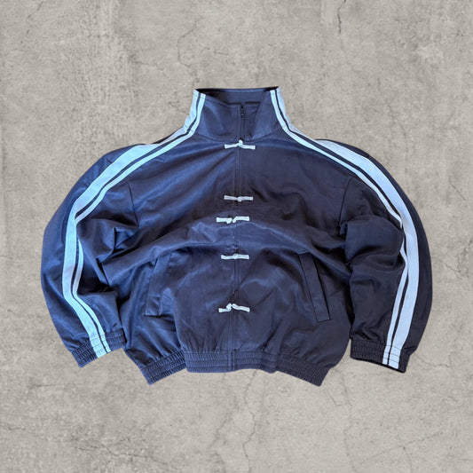 Grey boxy Korean zip-up sweatshirt jumper with navy blue stripes and toggle fastenings laid flat front view