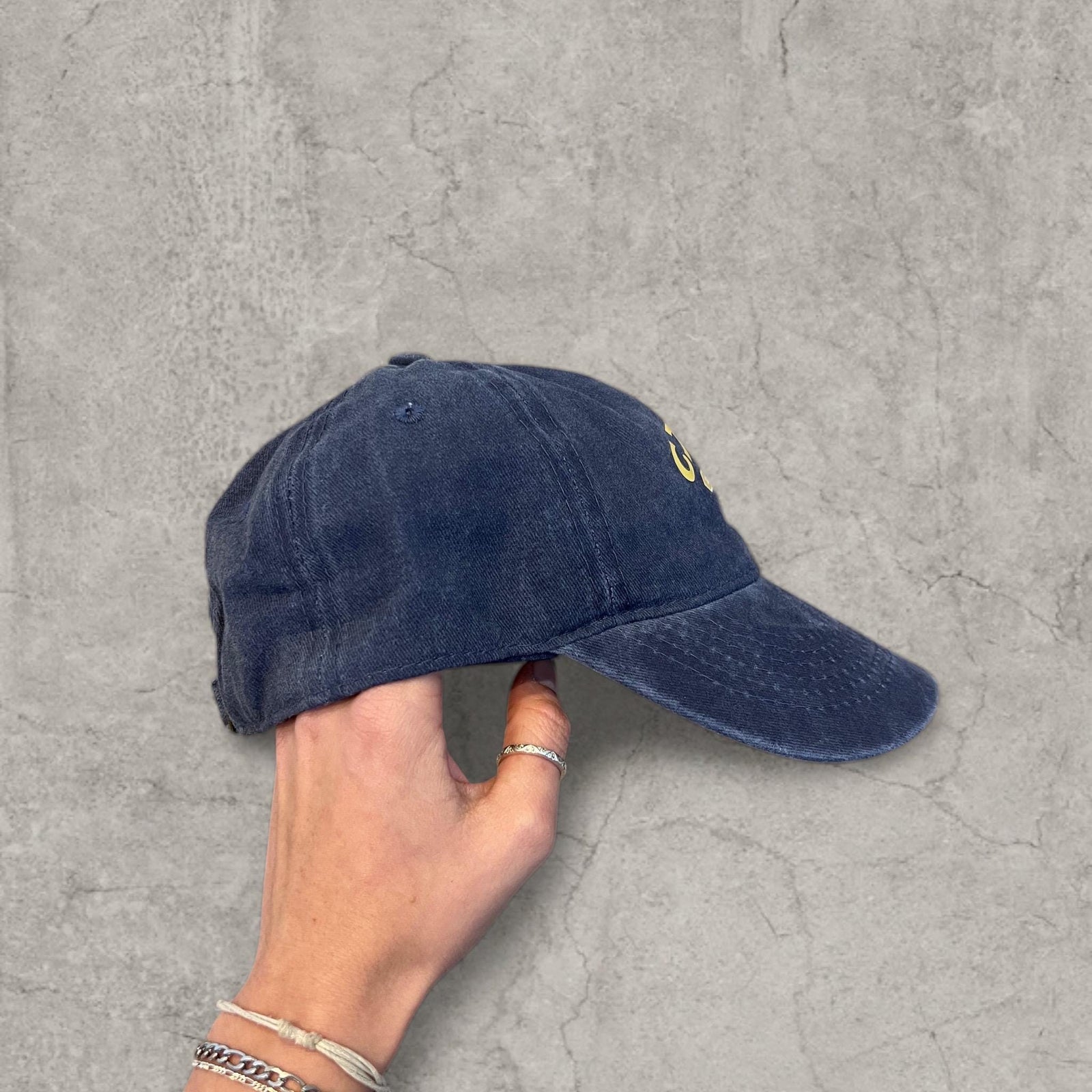 Vintage style baseball cap with yellow camel logo in navy blue