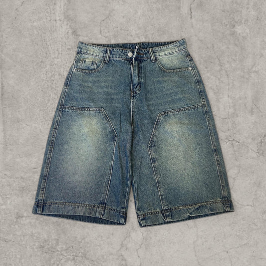 Front view of baggy relaxed fit Korean denim shorts in washed blue with panel detailing