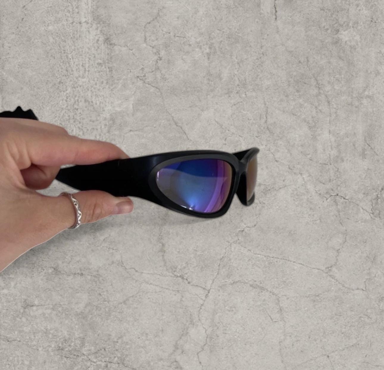 Insane alien sunglasses in black with reflective blue purple lenses. One size