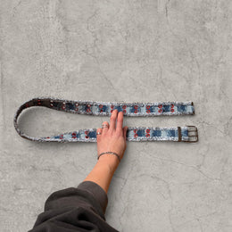 Cool distressed denim belt in navy and blue with red eyelet and silver metal buckle. Adjustable