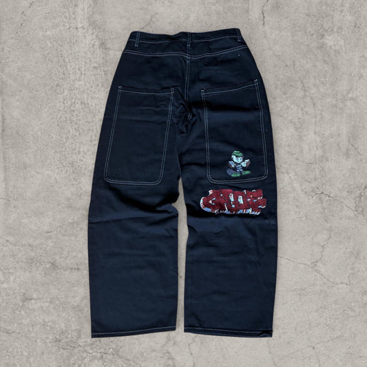 Back view of black wide-leg skater jeans with patch pockets and red embroidery