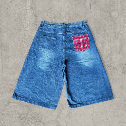 Washed blue baggy denim shorts jorts with red plaid pocket on back and wide legs