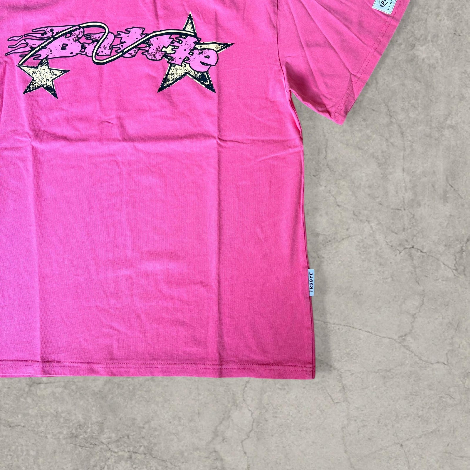 Battle vintage style T-shirt with back graphic in pink and black.