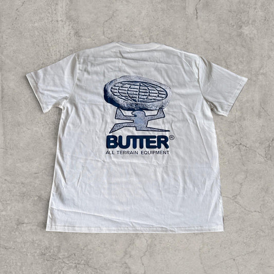 White T-shirt laid flat showing large blue graphic design on the back with brand name butter and circular emblem