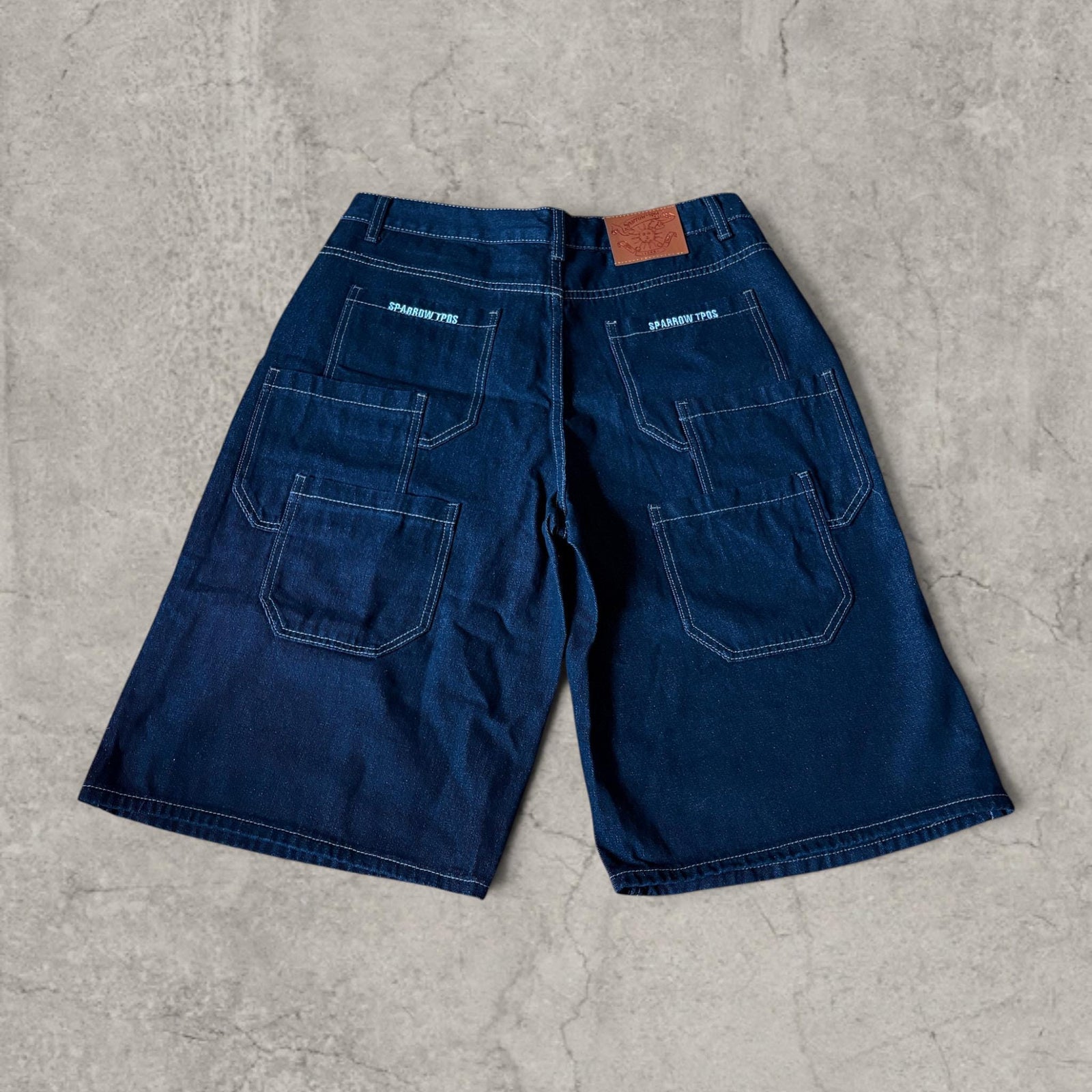 Retro 90s denim skater pocket jorts shorts in navy blue.