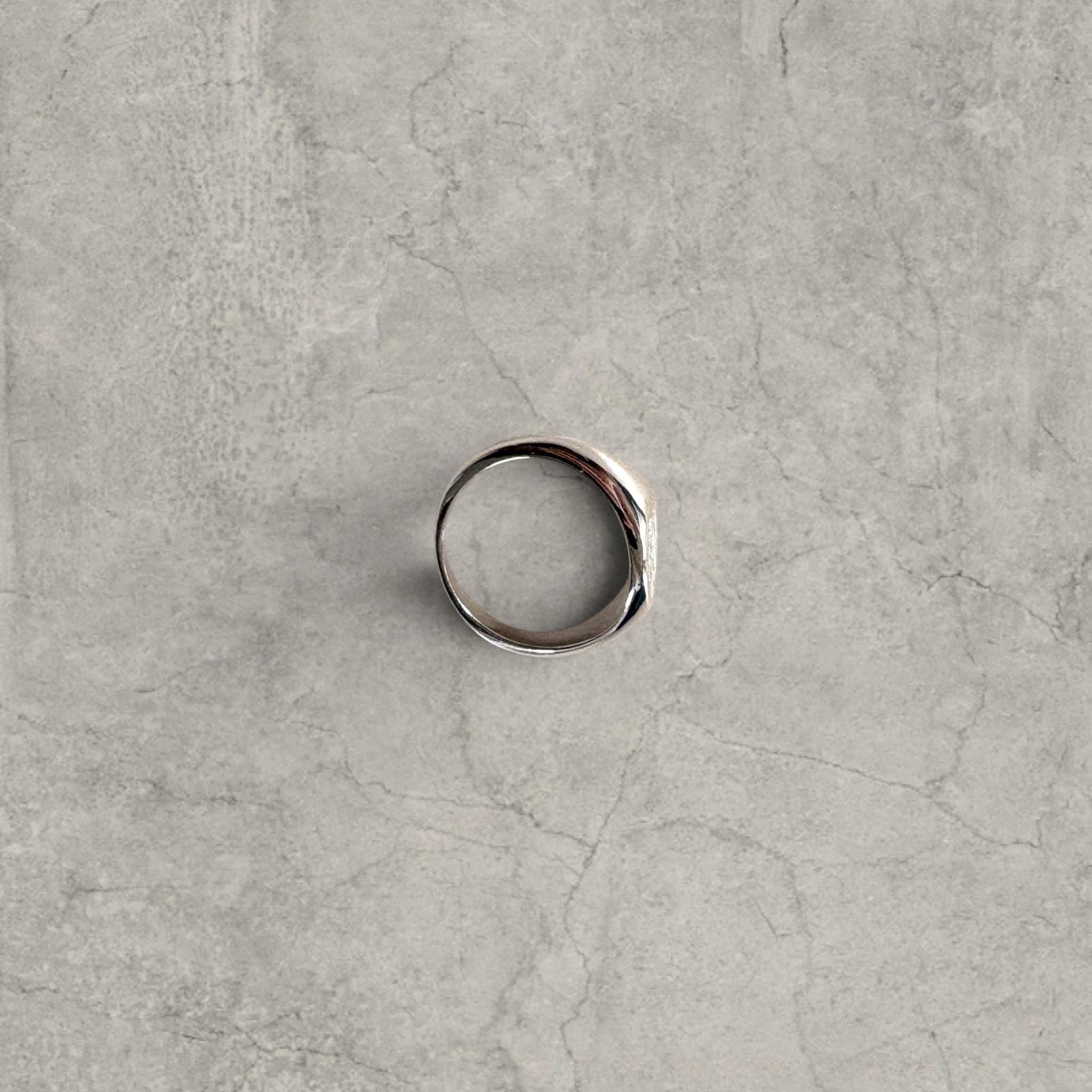 Cool vintage style silver colour stainless steel signet ring with engraved emblem.
