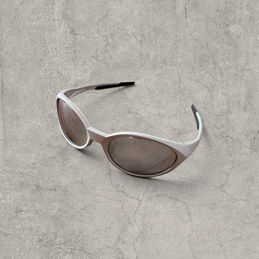 Silver Insane sunglasses with oval silver reflective lenses and straight arms on grey surface