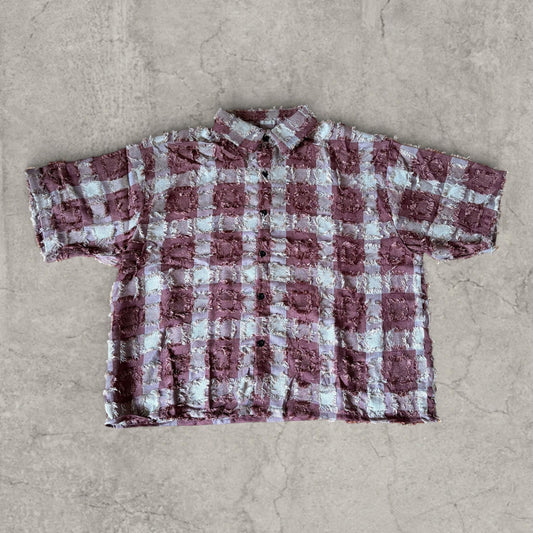 Boxy short-sleeve shirt with burgundy purple and white checkered textured fabric, laid flat front view