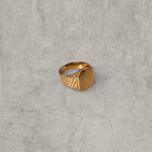 Gold colour stainless steel signet ring with square face and checkered detailing on band sides